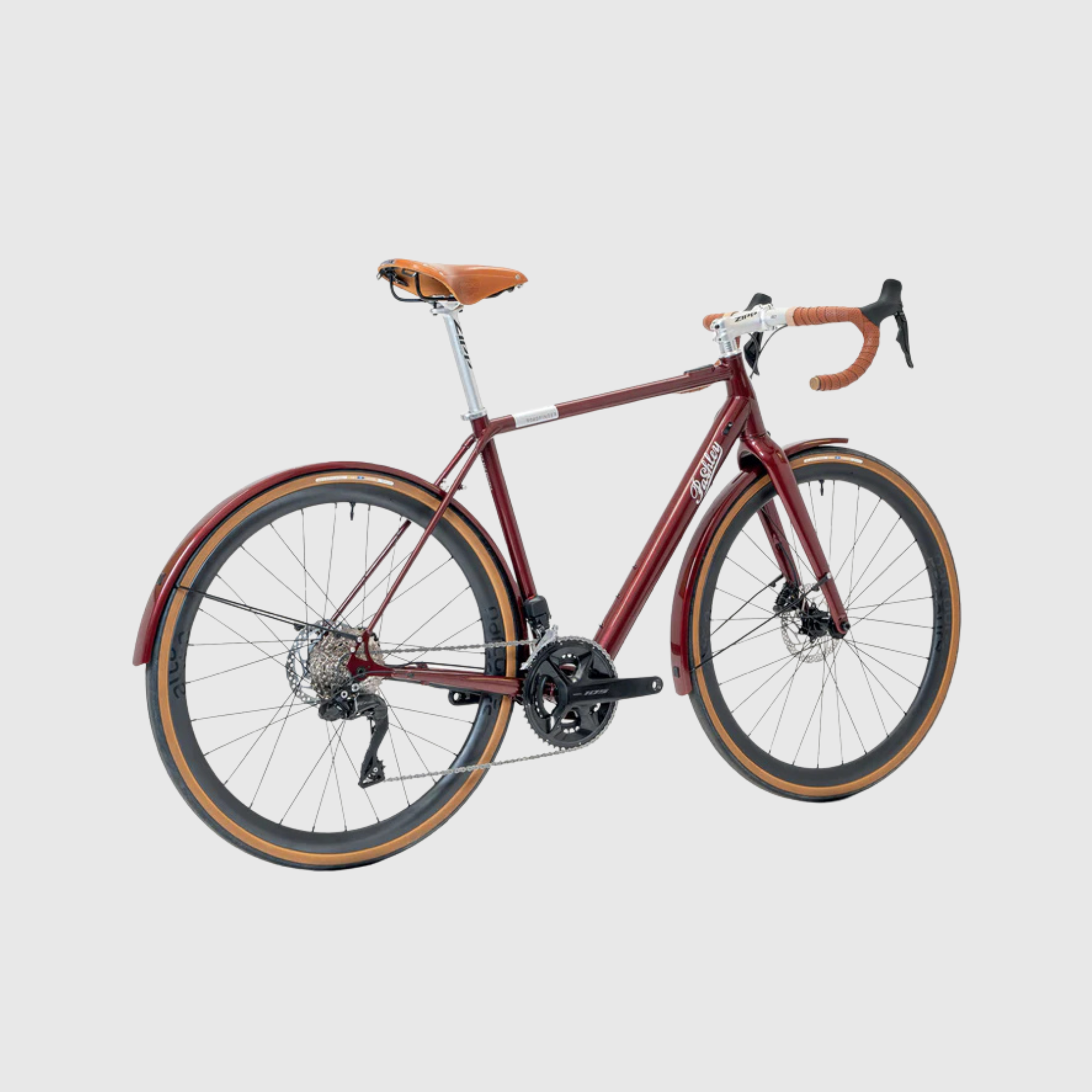 Red bicycle with brown handlebars on a light gray background