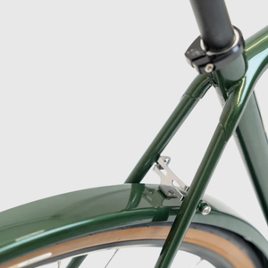 Close-up of a green bicycle frame with a white background
